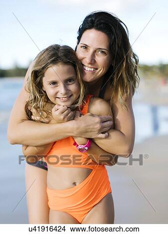 Woman with her daughter on beach View Large Photo Image Picture - Woman with her daughter on beach. Fotosearch