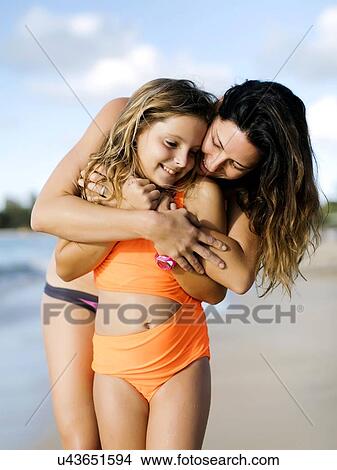 Woman with her daughter on beach View Large Photo Image Picture - Woman with her daughter on beach. Fotosearch
