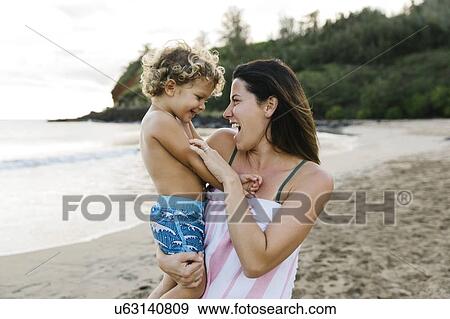 Woman with her son on beach View Large Photo Image Stock Photo - Woman with her son on beach. Fotosearch
