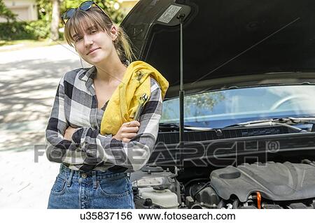 Woman with oil rag beside car View Large Photo Image Stock Photograph - Woman with oil rag beside car. Fotosearch
