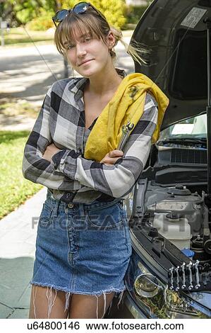 Woman with oil rag beside car View Large Photo Image Stock Photograph - Woman with oil rag beside car. Fotosearch
