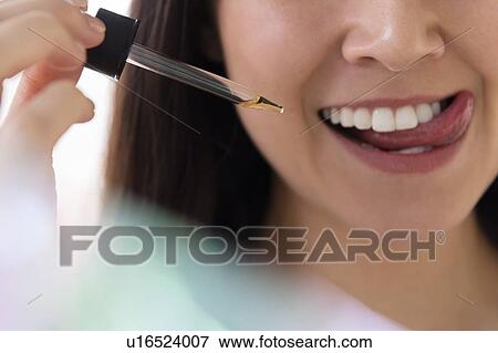 Woman with pipette of essential oil View Large Photo Image Stock Photo - Woman with pipette of essential oil. Fotosearch