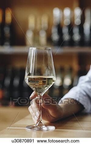 Woman's hand holding glass of white wine View Large Photo Image Stock Image - Woman's hand holding glass of white wine. Fotosearch