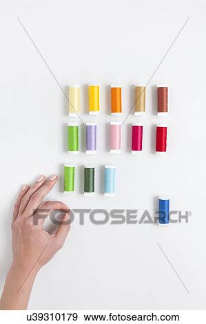 Stock Photo - Woman's hand selecting thread. Fotosearch