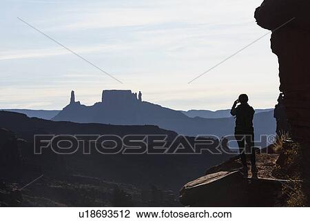 Stock Image - Woman's silhouette by Fisher Towers in Utah, USA. Fotosearch