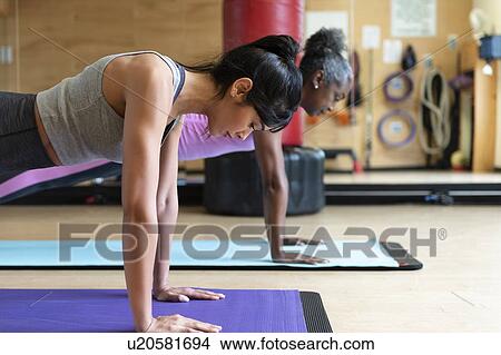 Picture - Women doing yoga in gym. Fotosearch