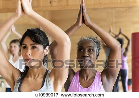 Stock Photo - Women doing yoga in gym. Fotosearch