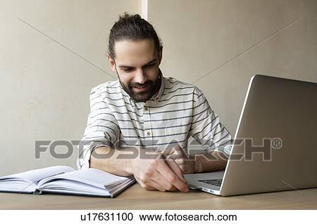 Young businessman putting USB stick into laptop View Large Photo Image Stock Image - Young businessman putting USB stick into laptop. Fotosearch