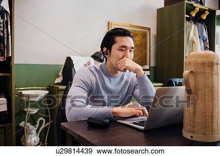 Young businessman remote working on laptop at cafe table View Large Photo Image Stock Photo - Young businessman remote working on laptop at cafe table. Fotosearch