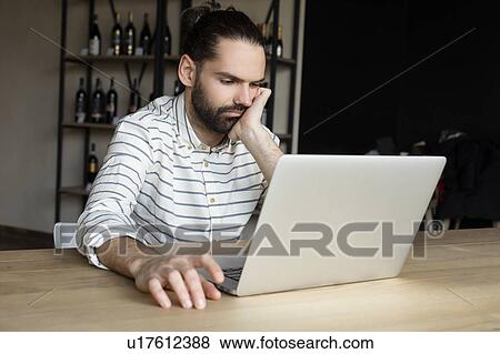 Young businessman using laptop View Large Photo Image Stock Photo - Young businessman using laptop. Fotosearch