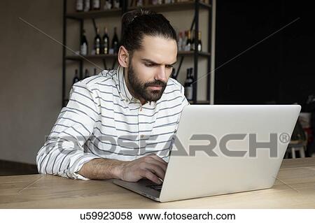 Young businessman using laptop View Large Photo Image Stock Photo - Young businessman using laptop. Fotosearch