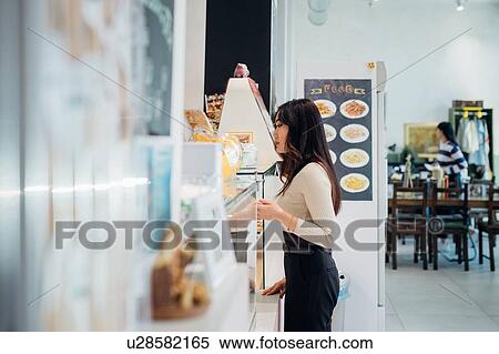 Young businesswoman at cafe counter View Large Photo Image Stock Photography - Young businesswoman at cafe counter. Fotosearch