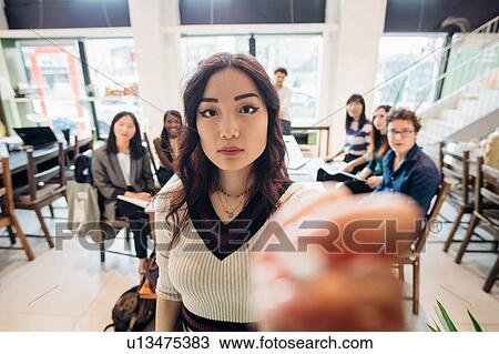 Young businesswoman preparing for presentation to colleagues View Large Photo Image Stock Image - Young businesswoman preparing for presentation to colleagues. Fotosearch