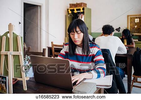 Young businesswoman remote working on laptop at cafe table View Large Photo Image Stock Image - Young businesswoman remote working on laptop at cafe table. Fotosearch