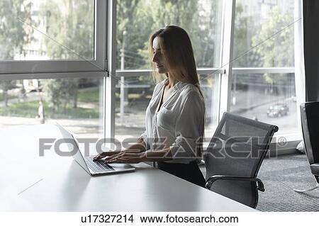Young businesswoman working on laptop View Large Photo Image Picture - Young businesswoman working on laptop. Fotosearch