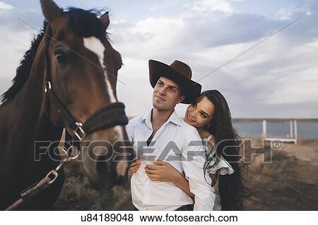 Young couple by horse View Large Photo Image Stock Photo - Young couple by horse. Fotosearch