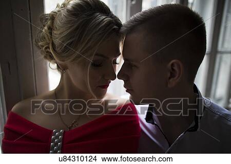 Young couple face to face by window View Large Photo Image Picture - Young couple face to face by window. Fotosearch
