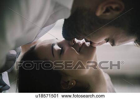 Stock Image - Young couple face to face with their eyes closed. Fotosearch