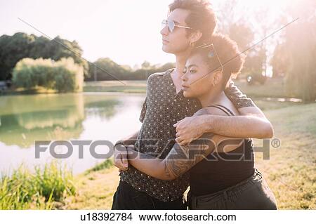 Young couple hugging by lake View Large Photo Image Picture - Young couple hugging by lake. Fotosearch