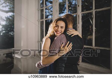 Young couple hugging by window View Large Photo Image Stock Photo - Young couple hugging by window. Fotosearch