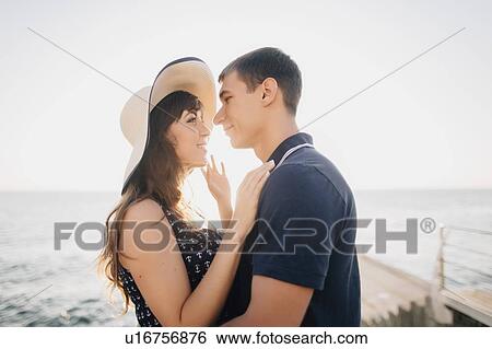 Young couple on pier View Large Photo Image Stock Photograph - Young couple on pier. Fotosearch