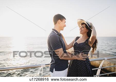 Young couple on pier View Large Photo Image Stock Photograph - Young couple on pier. Fotosearch