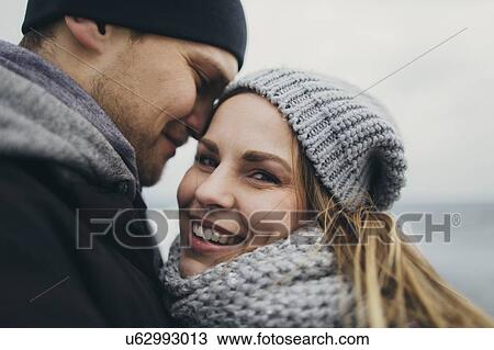 Stock Image - Young couple wearing warm clothing. Fotosearch