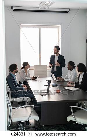 Young female and male business creative team at conference table presentation View Large Photo Image Stock Image - Young female and male business creative team at conference table presentation. Fotosearch