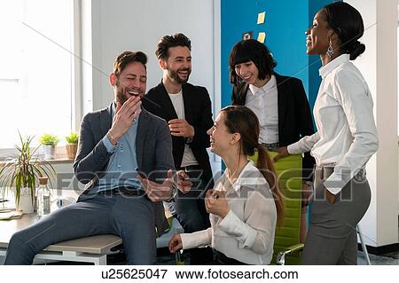 Young female and male business creative team laughing in office View Large Photo Image Stock Photo - Young female and male business creative team laughing in office. Fotosearch