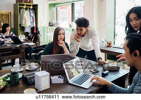 Young female and male business team meeting at cafe table View Large Photo Image Stock Image - Young female and male business team meeting at cafe table. Fotosearch