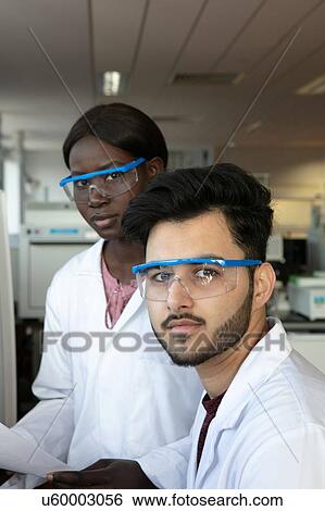 Young female and male scientists in laboratory, portrait View Large Photo Image Stock Photograph - Young female and male scientists in laboratory, portrait. Fotosearch