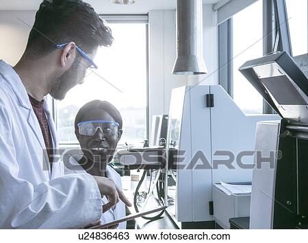 Young female and male scientists using digital tablet and having discussion in laboratory View Large Photo Image Stock Image - Young female and male scientists using digital tablet and having discussion in laboratory. Fotosearch