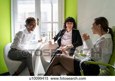 Young female business creative team taking a break in office armchairs View Large Photo Image Stock Photography - Young female business creative team taking a break in office armchairs. Fotosearch