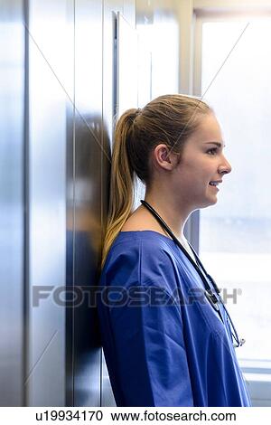 Young female junior doctor in hospital elevator View Large Photo Image Stock Image - Young female junior doctor in hospital elevator. Fotosearch