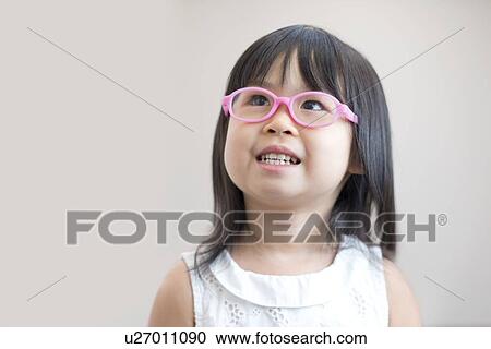 Young girl wearing pink glasses, studio shot. View Large Photo Image Stock Image - Young girl wearing pink glasses, studio shot.. Fotosearch