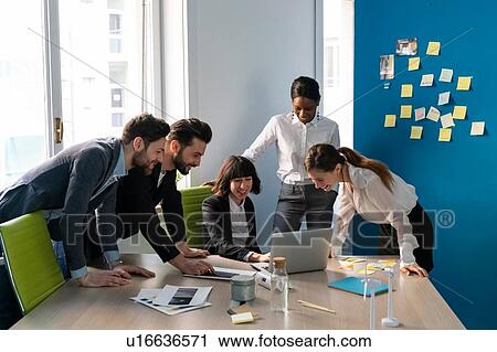 Young male and female business creative team looking at laptop in office View Large Photo Image Stock Image - Young male and female business creative team looking at laptop in office. Fotosearch