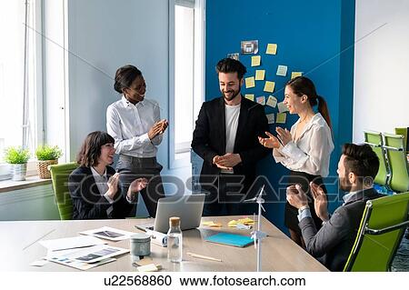 Young male and female business creative team applauding each other in office meeting View Large Photo Image Stock Image - Young male and female business creative team applauding each other in office meeting. Fotosearch