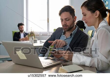 Young male and female business creative teams sharing meetings in open plan office View Large Photo Image Stock Photo - Young male and female business creative teams sharing meetings in open plan office. Fotosearch