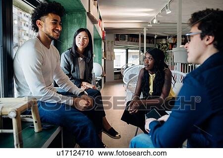 Young male and female business team having informal meeting View Large Photo Image Stock Image - Young male and female business team having informal meeting. Fotosearch