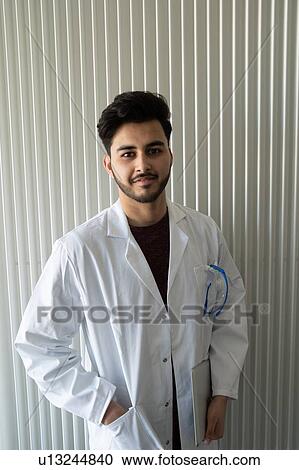 Young male scientist in laboratory holding notebook, portrait View Large Photo Image Stock Image - Young male scientist in laboratory holding notebook, portrait. Fotosearch