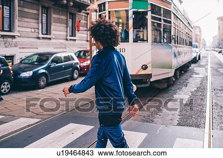 Stock Image - Young man exploring city, Milano, Lombardia, Italy. Fotosearch