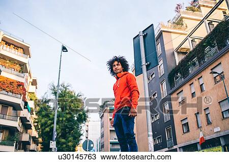 Stock Image - Young man exploring city, Milano, Lombardia, Italy. Fotosearch