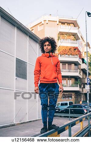 Stock Photo - Young man exploring city, Milano, Lombardia, Italy. Fotosearch