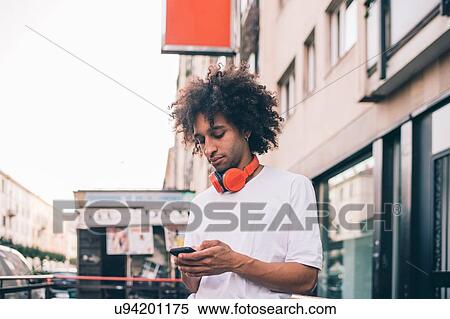 Stock Photography - Young man exploring city, Milano, Lombardia, Italy. Fotosearch