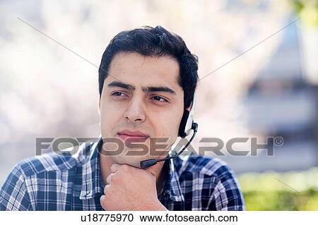 Young man in deep thought outdoors View Large Photo Image Stock Image - Young man in deep thought outdoors. Fotosearch