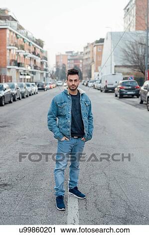 Young man in middle of street, Milano, Lombardia, Italy View Large Photo Image Stock Image - Young man in middle of street, Milano, Lombardia, Italy. Fotosearch