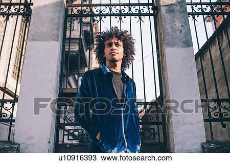 Young man waiting in front of gate, Milano, Lombardia, Italy View Large Photo Image Stock Image - Young man waiting in front of gate, Milano, Lombardia, Italy. Fotosearch