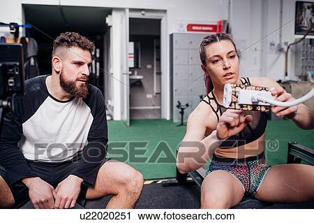 Young woman and man training together, setting rowing machine controls in gym View Large Photo Image Stock Image - Young woman and man training together, setting rowing machine controls in gym. Fotosearch