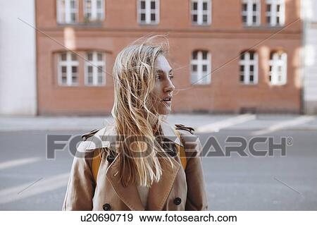 Young woman by brick building View Large Photo Image Stock Photo - Young woman by brick building. Fotosearch