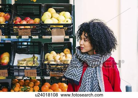 Young woman by crates of fruit View Large Photo Image Stock Photo - Young woman by crates of fruit. Fotosearch